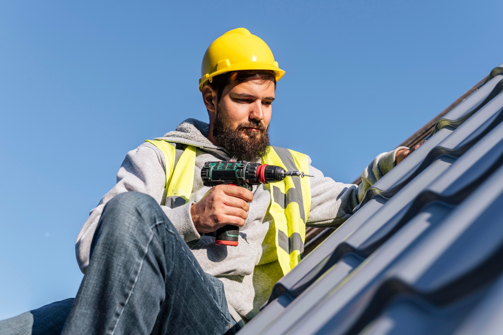 Professional roofing contractor with hard hat on tile roof — roofing website design and SEO